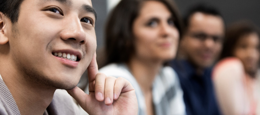 A close-up of a person touching his chin.