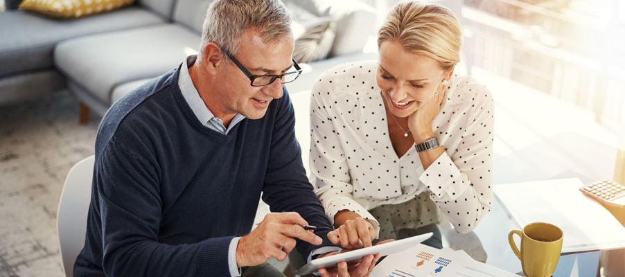 Two people looking at a tablet.