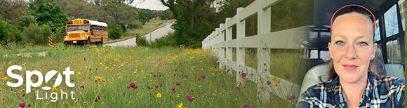 Decorative. Text-based logo reading spotlight is in the lower left corner over top of a photograph of a school bus on a road next to grass filled with wildflowers. A horse fence is to the right. On the far right is a portrait of Bianca Patterson in the driver